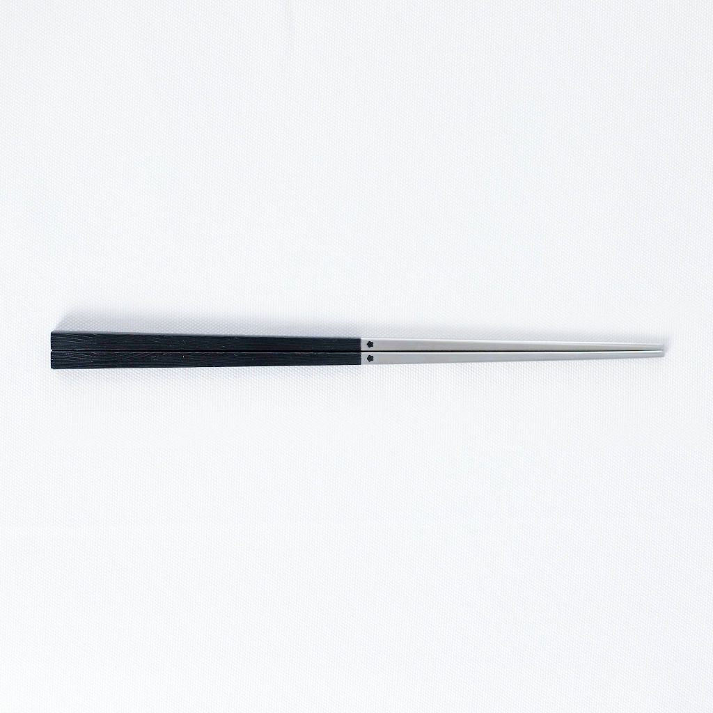 Radiko 316 stainless steel chopsticks with wood-grain handles in black, on a white background