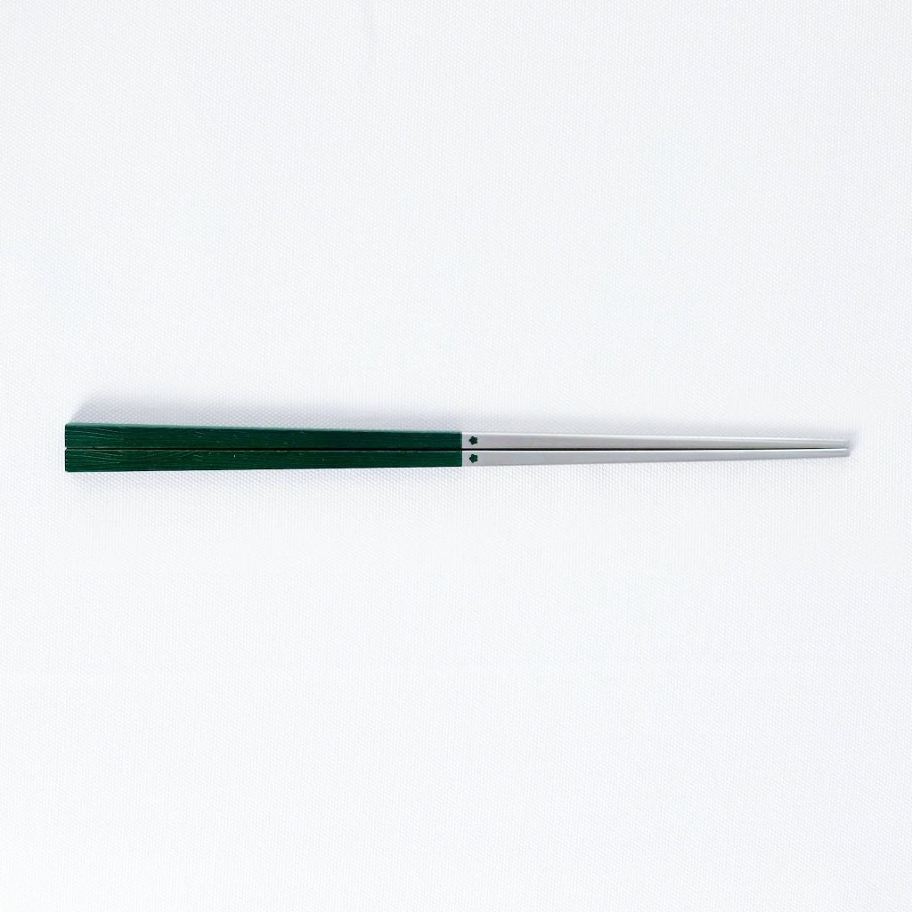 Radiko 316 stainless steel chopsticks with wood-grain handles in green, on a white background