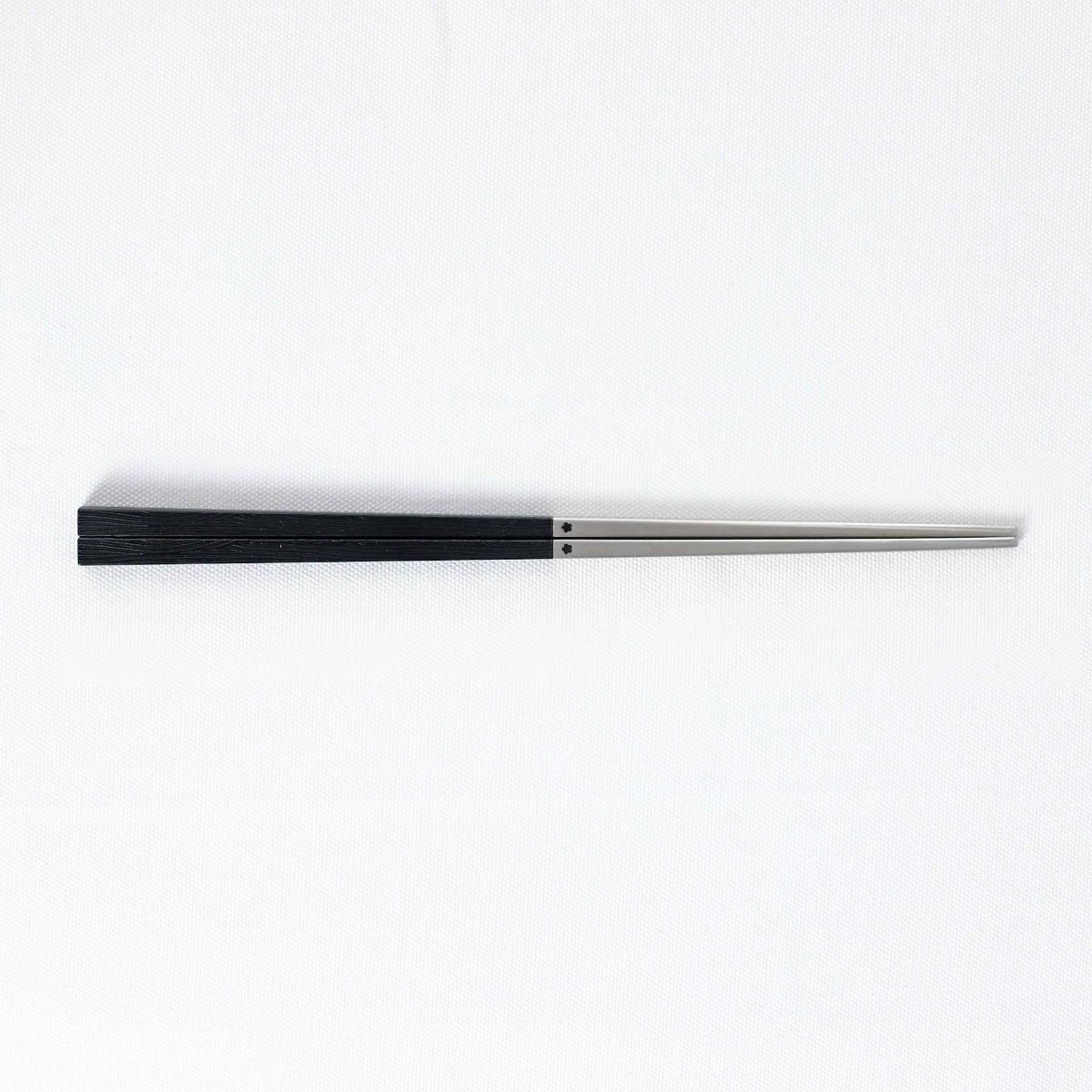 Radiko 316 stainless steel chopsticks in black with wood-grain textured square handles and metallic silver tips.