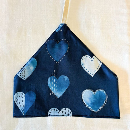 Utensil Wrap Navy blue fabric with blue heart patterns on a beige background