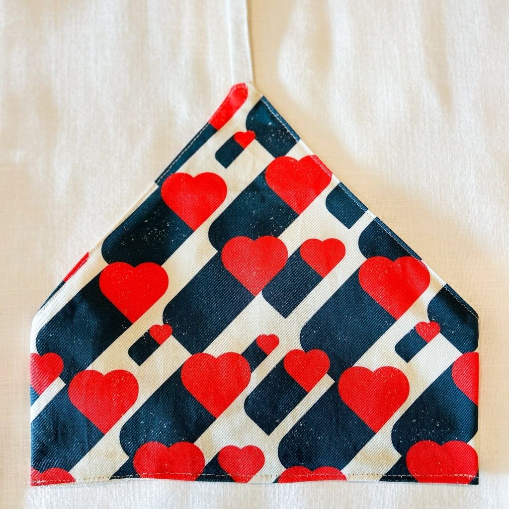 Red heart and navy blue geometric print fabric wrap with finished edges, styled as Valentine's Day gift packaging, on a beige background.
