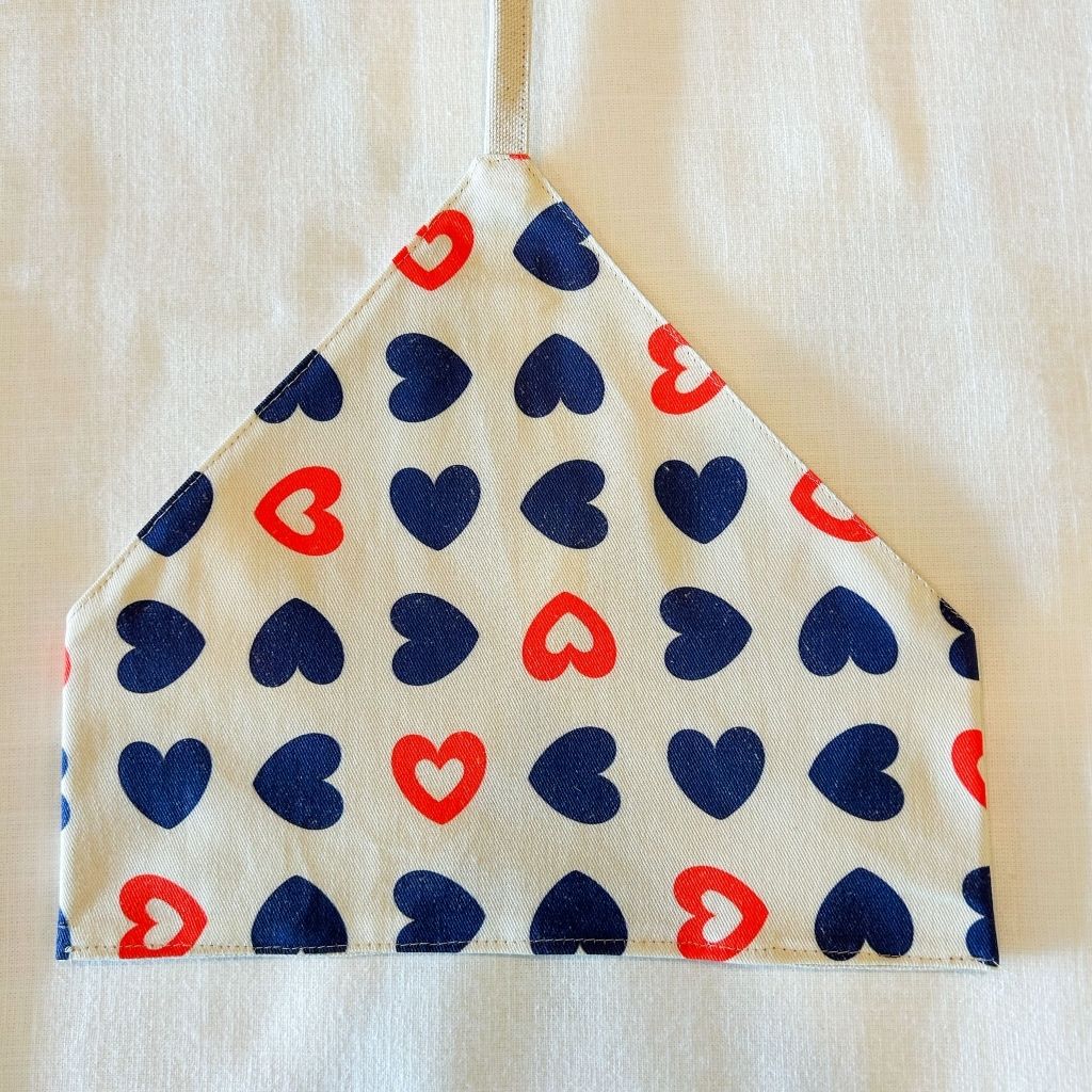 utensil wrap with red and blue heart pattern on a beige background